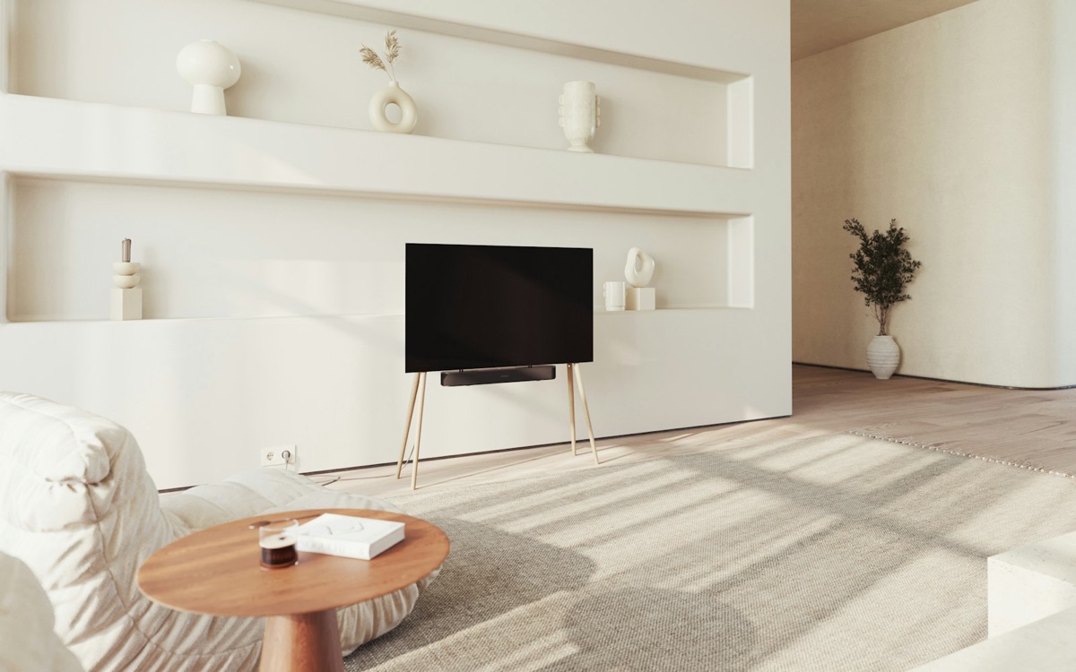 A modern, minimalist living room with a large flat-screen television on a wooden stand